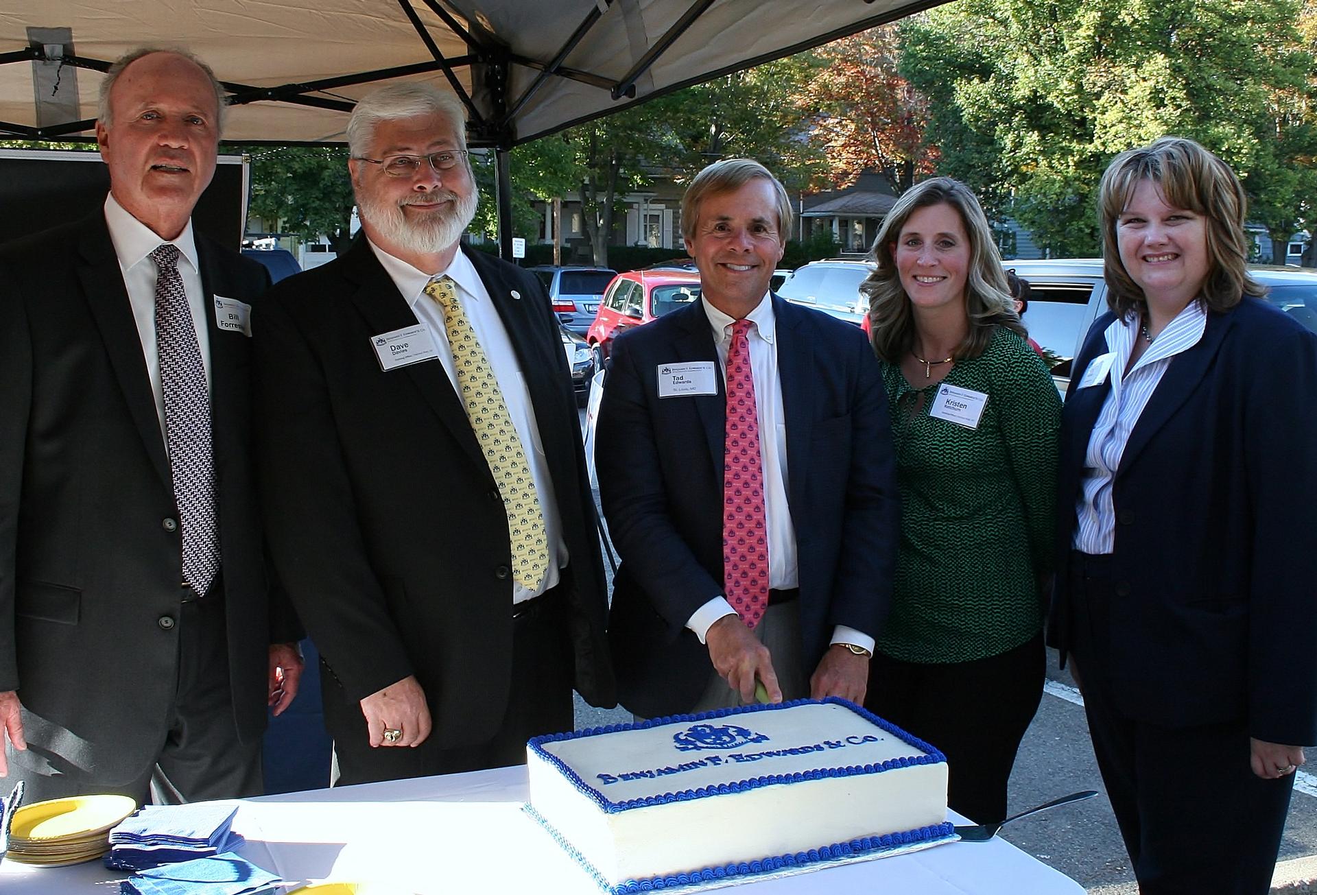 Group at business event with ceremonial cake